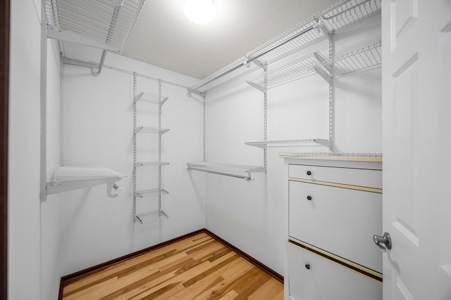 spacious closet with light wood-style floors