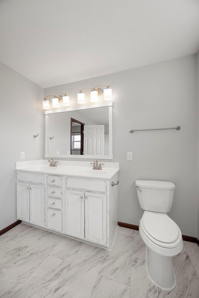 full bathroom with baseboards, marble finish floor, and a sink