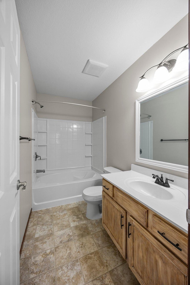 bathroom featuring shower / bathing tub combination, toilet, vanity, and a textured ceiling