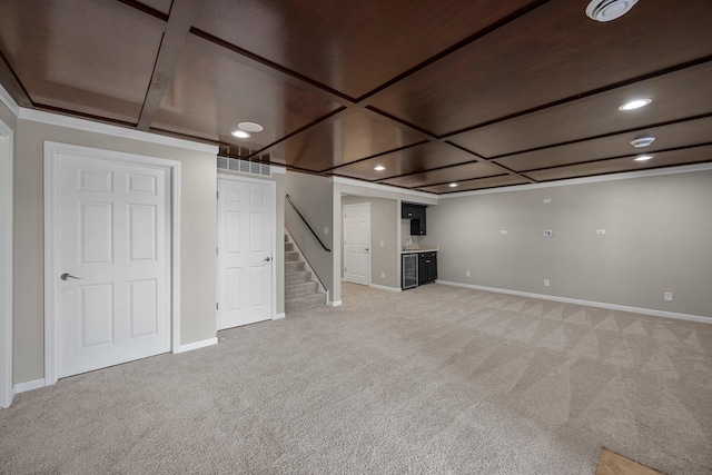 finished below grade area featuring visible vents, baseboards, recessed lighting, stairs, and light colored carpet