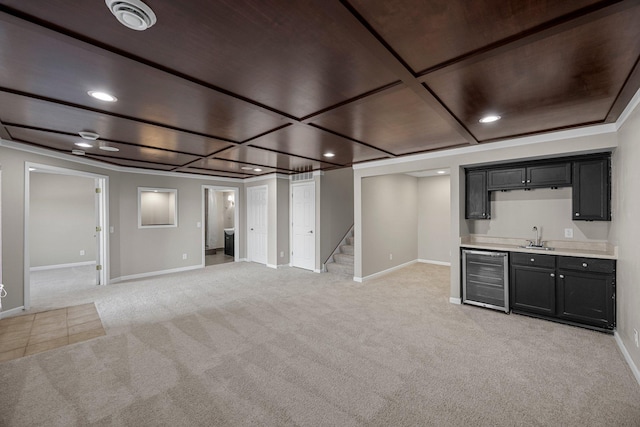 finished below grade area with stairway, wet bar, a sink, wine cooler, and light carpet