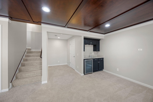 finished below grade area with a sink, stairway, wine cooler, wet bar, and light colored carpet