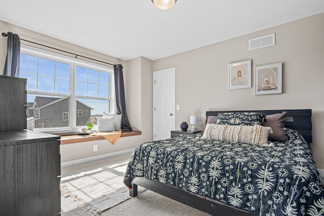 bedroom featuring visible vents, carpet floors, and baseboards