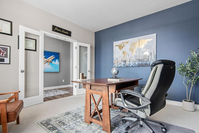 carpeted office with french doors, baseboards, and a textured ceiling