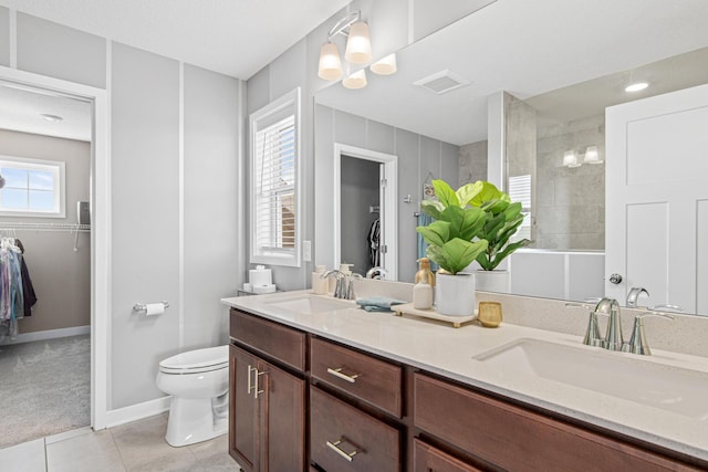 full bath featuring a sink, visible vents, tile patterned floors, and a walk in shower