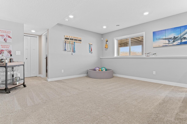 game room with recessed lighting, carpet, baseboards, and a textured ceiling