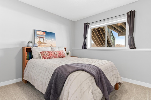 carpeted bedroom featuring baseboards