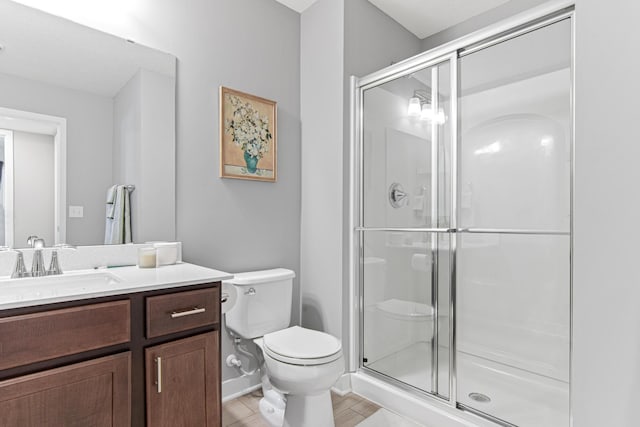 full bath featuring a shower stall, toilet, and vanity