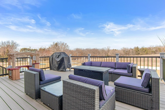 wooden terrace featuring an outdoor living space and grilling area