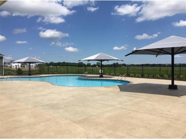 view of pool with a fenced in pool, a patio, and fence