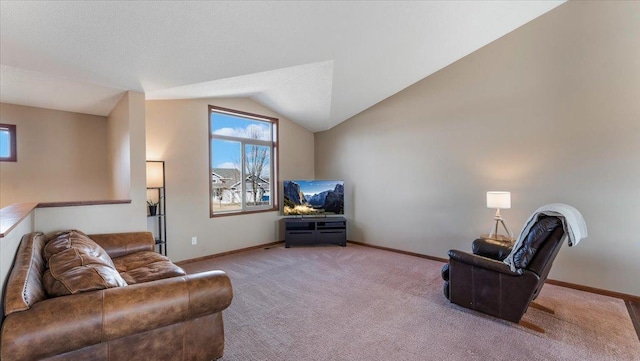 carpeted living area featuring baseboards and vaulted ceiling