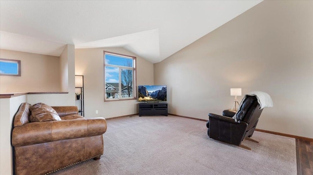 living area with baseboards, carpet floors, and vaulted ceiling