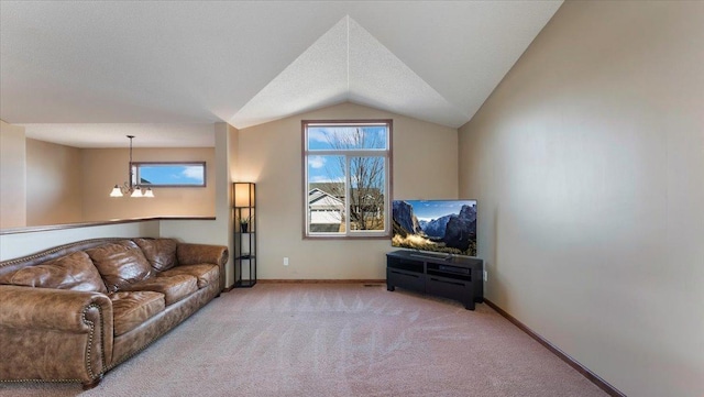 carpeted living area featuring baseboards, lofted ceiling, and an inviting chandelier