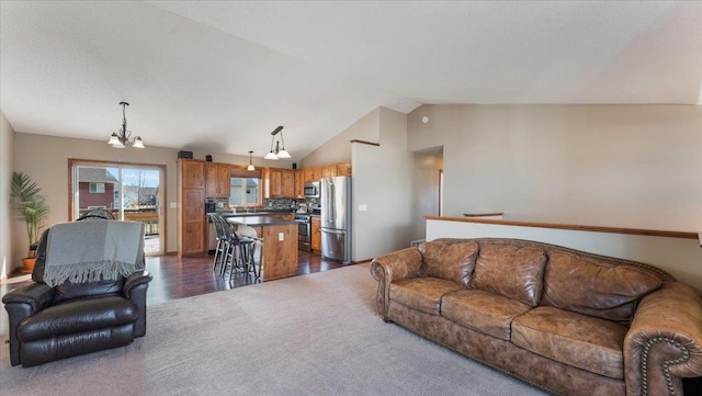 living area featuring a notable chandelier, dark carpet, dark wood-style flooring, and vaulted ceiling