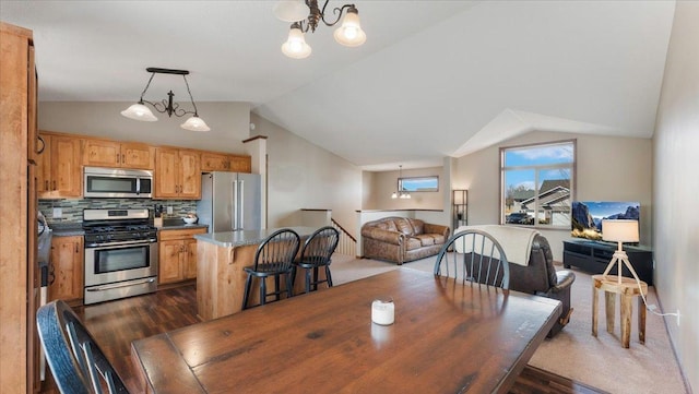 dining area featuring an inviting chandelier, lofted ceiling, and dark wood-style flooring