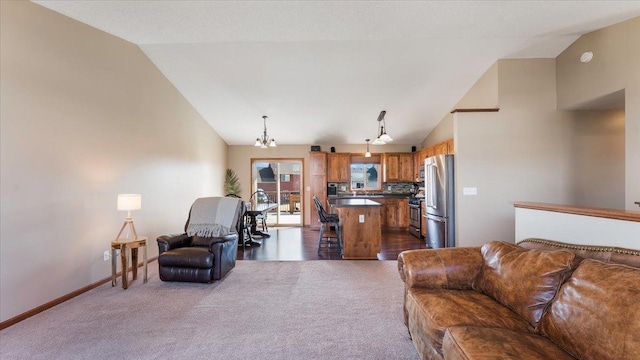 living area with a notable chandelier, baseboards, high vaulted ceiling, and dark carpet