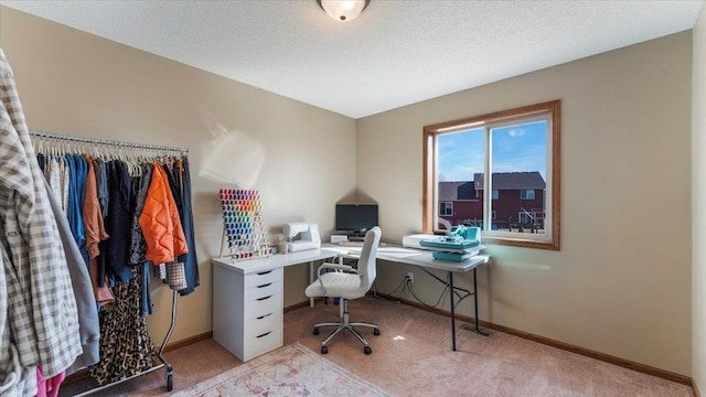 office space featuring baseboards, light colored carpet, and a textured ceiling