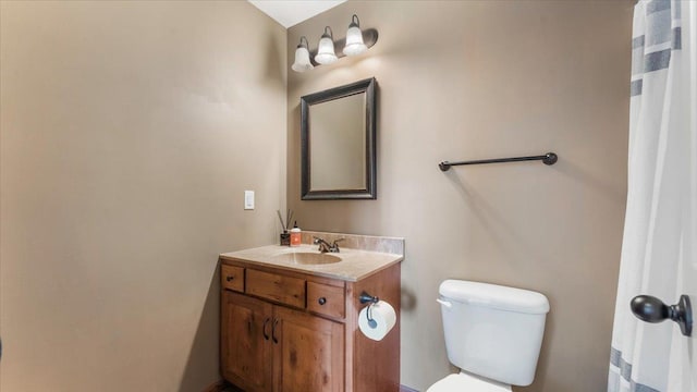 bathroom featuring toilet and vanity