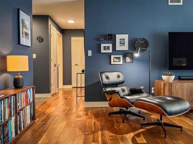 office with visible vents, baseboards, and wood finished floors