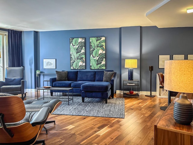 living area featuring baseboards and wood finished floors