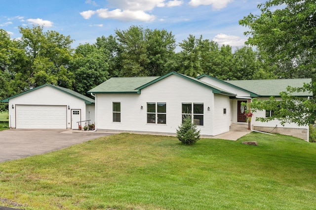 view of front of property featuring a garage, an outbuilding, and a front yard