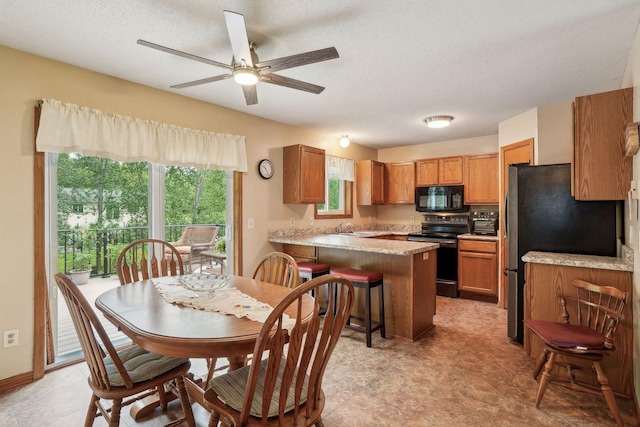 dining space with a textured ceiling and a ceiling fan