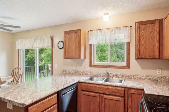 kitchen featuring a peninsula, a sink, light countertops, a textured ceiling, and stainless steel dishwasher