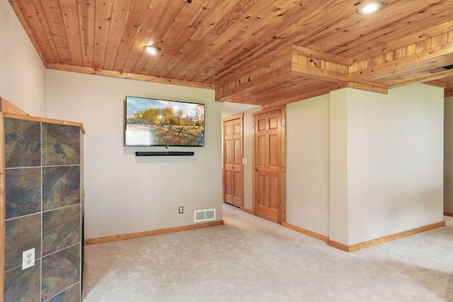 carpeted spare room featuring visible vents, baseboards, and wood ceiling