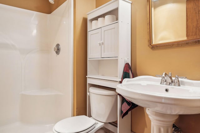 full bathroom with a sink, toilet, and walk in shower