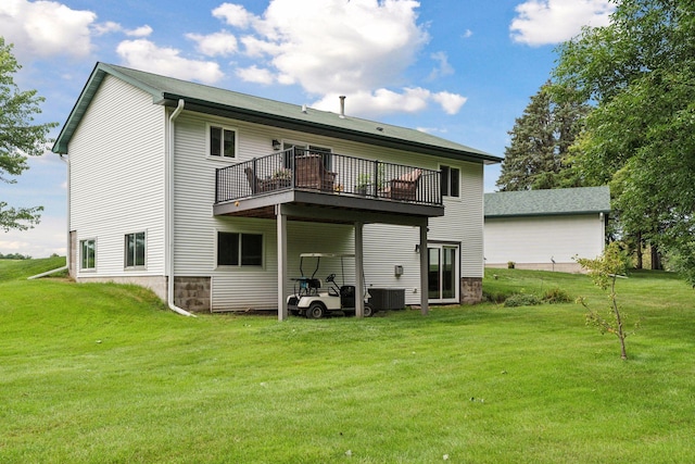 back of property featuring a wooden deck and a yard