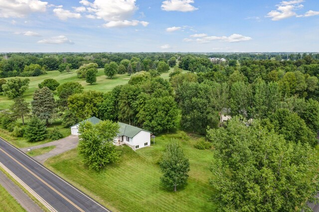 birds eye view of property featuring a wooded view