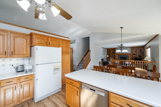 kitchen featuring vaulted ceiling, light countertops, light wood-style floors, white fridge with ice dispenser, and dishwasher