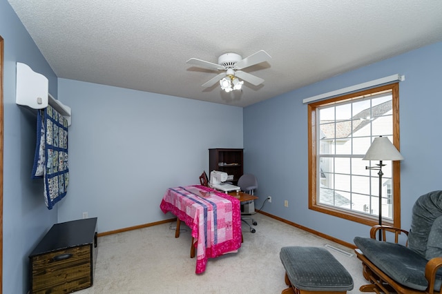 bedroom featuring ceiling fan, a textured ceiling, baseboards, and carpet floors