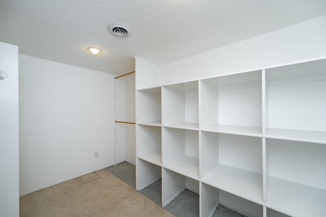 below grade area featuring visible vents and a textured ceiling