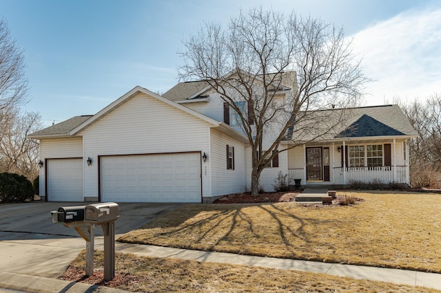 traditional-style home with a front yard, driveway, roof with shingles, covered porch, and a garage