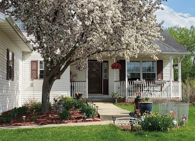 view of front of property with a porch and a shingled roof