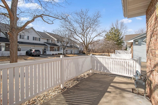 view of patio / terrace featuring a residential view and fence