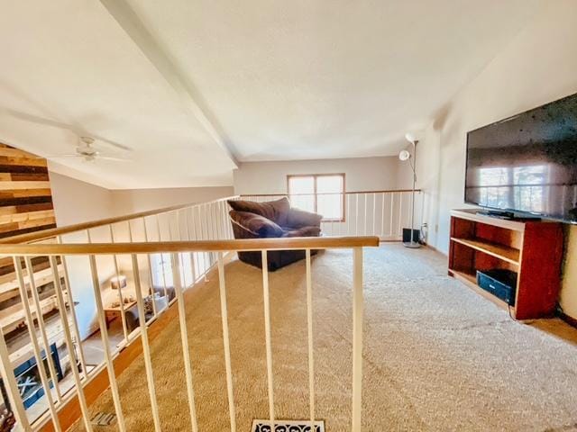 unfurnished living room featuring ceiling fan, lofted ceiling, and carpet floors