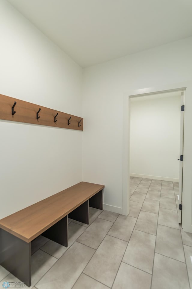 mudroom featuring light tile patterned flooring and baseboards