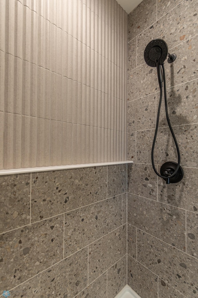 bathroom with tiled shower