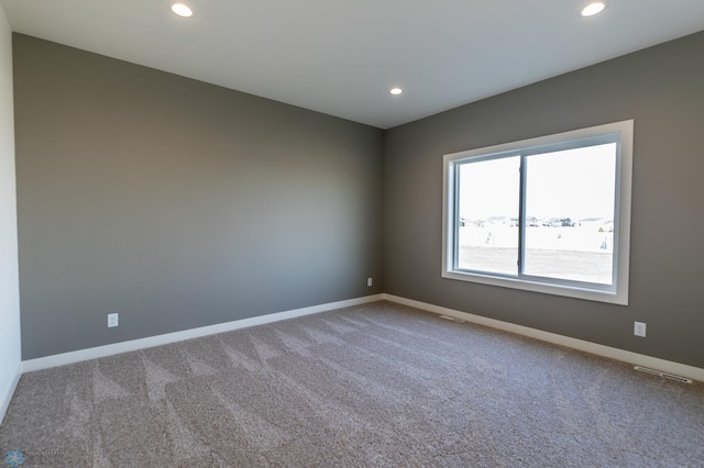 spare room featuring baseboards, carpet flooring, and recessed lighting
