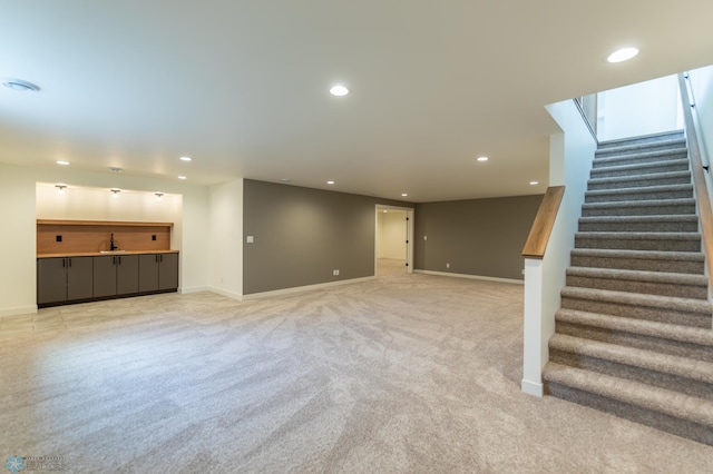 finished below grade area with stairs, recessed lighting, and light colored carpet