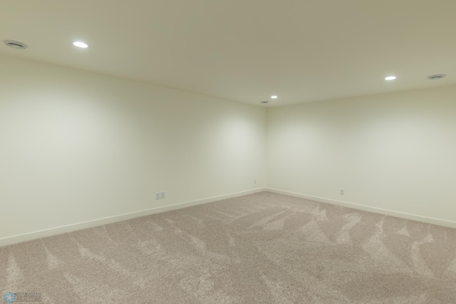 spare room featuring baseboards, light colored carpet, and recessed lighting