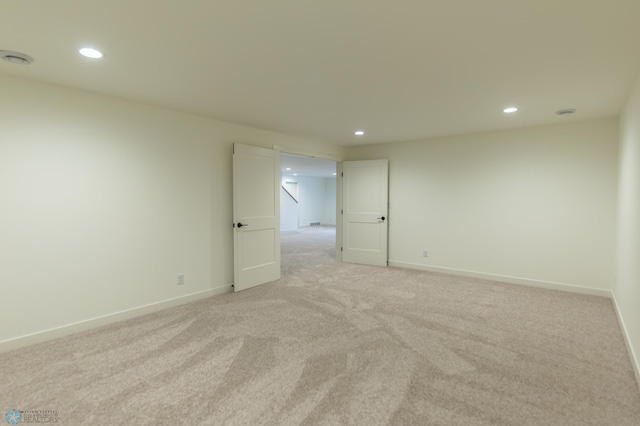 unfurnished room featuring baseboards, recessed lighting, and light colored carpet