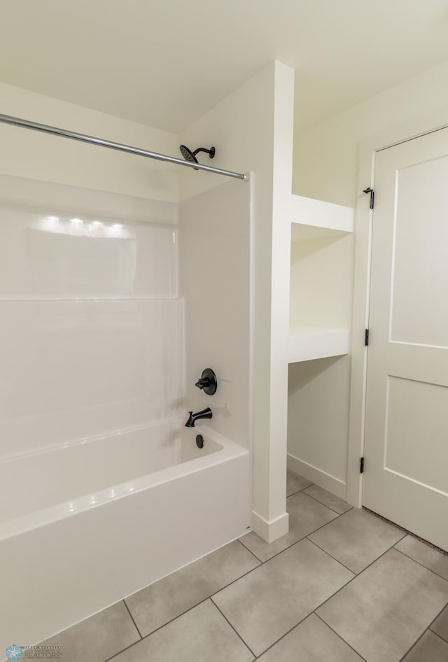 bathroom with tile patterned floors and bathtub / shower combination