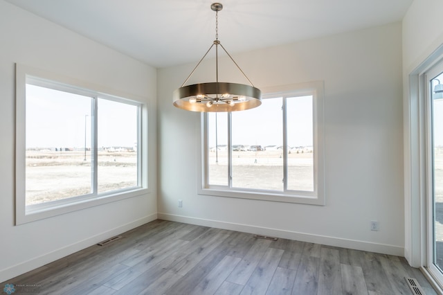 8319 59th St S, Horace, ND 58047 - spare room featuring a chandelier and light wood-style floors