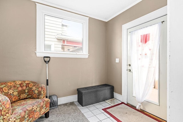 entrance foyer featuring light tile patterned floors, baseboards, and crown molding