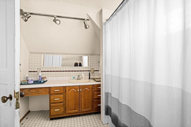 bathroom with vanity, tile walls, a shower with curtain, and tile patterned flooring