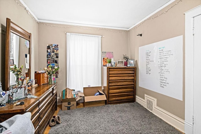 interior space with visible vents, carpet, and crown molding