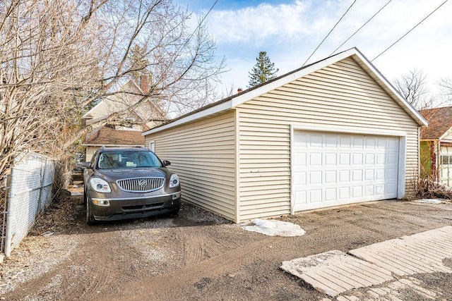 detached garage featuring fence